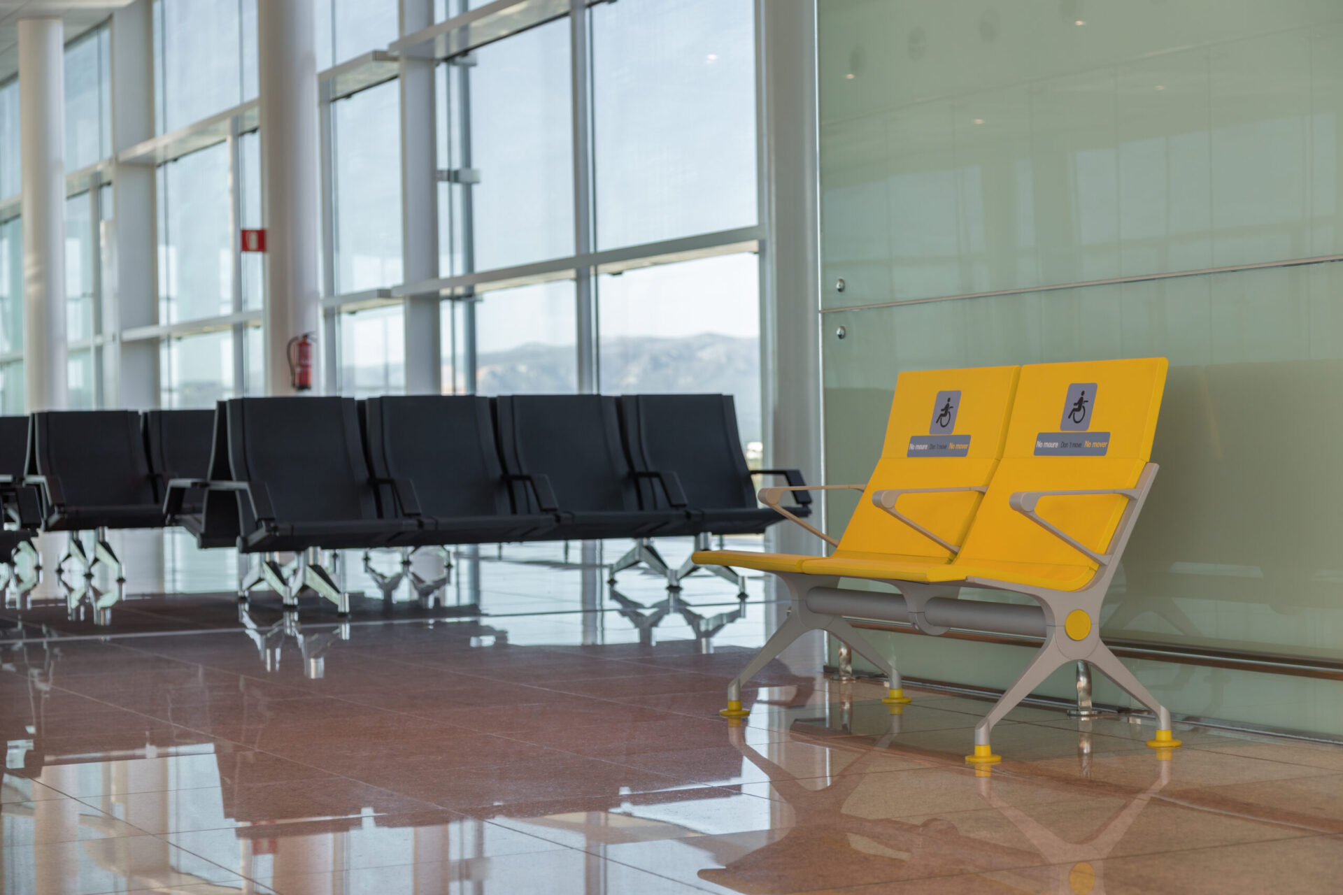 Empty priority seats in international airport reserved for disabled people. Normal and yellow disabled seats in the waiting area before boarding.